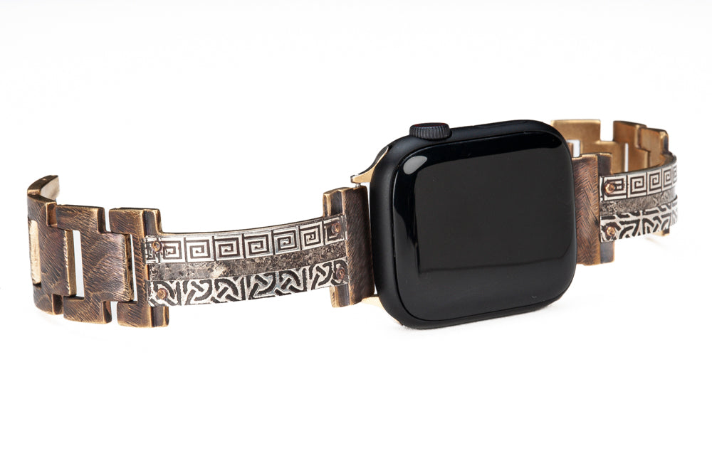 Our bestselling sterling silver Apple watch band, now in narrow. Slices of sterling silver are embossed with Celtic and Greek designs and then riveted by hand onto a solid metal band. Bard sterling silver iWatch facing to the right.