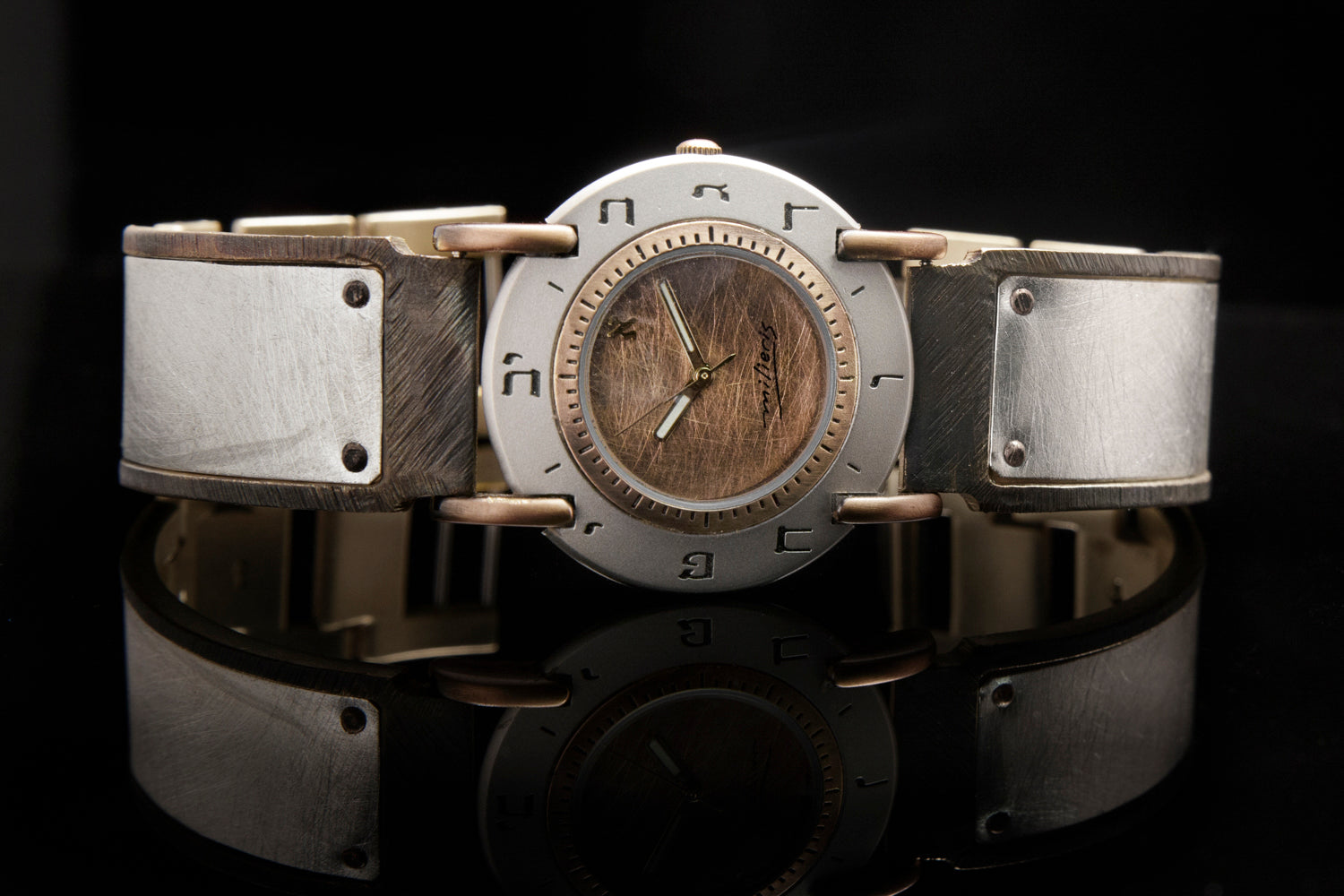 Front view of a large sterling silver watch with a brushed copper dial and Hebrew numerals, wide brass and sterling silver band, black background - ALEPH Luna
