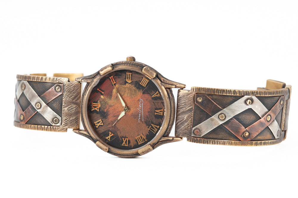 The Juggler is a unique watch for men and women. Interlacing stripes of sterling silver and copper are hand-riveted to the solid metal band. Look closely and you can see the hammer marks that give each watch such a unique texture and design.