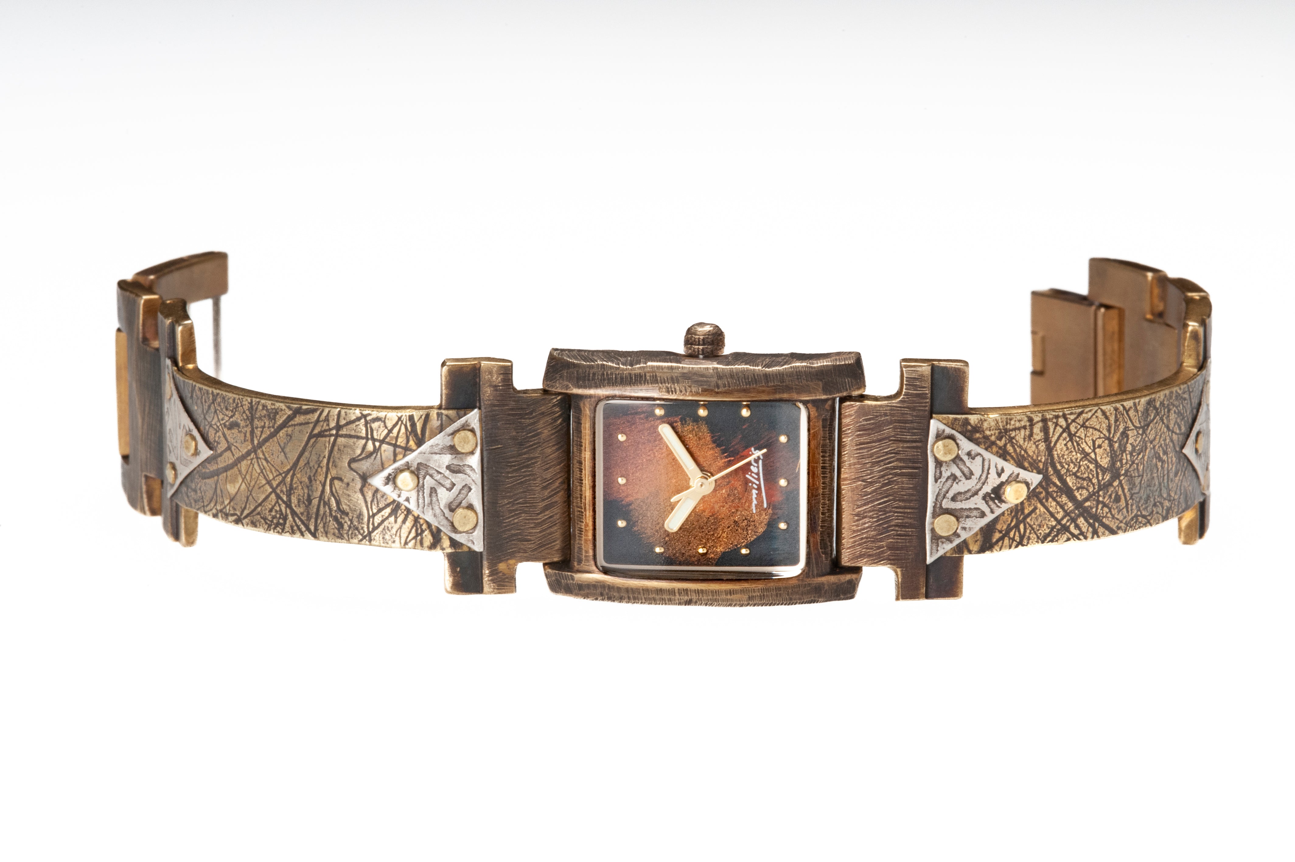 The Ponte Vecchio watch in brass and silver, facing front. Note the domed glass that marks the FLORENCE collection. The silver triangles are embossed with Celtic designs while you can see the patterns of the handmade coconut paper pressed onto the brass watch band.