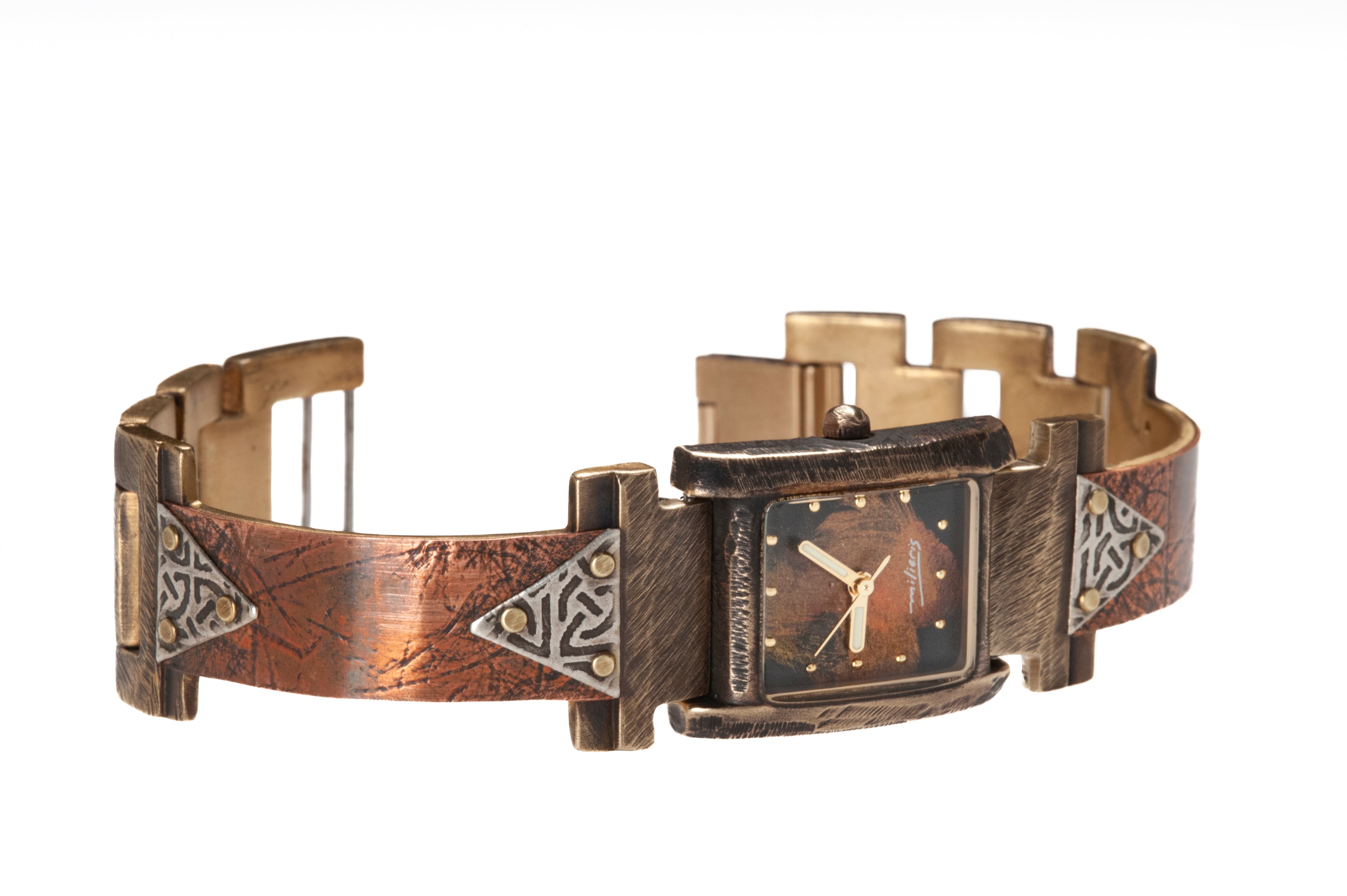 The Ponte Vecchio watch in copper and silver, facing right. Note the domed glass that marks the FLORENCE collection. Silver triangles embossed with Celtic designs are hand-riveted to both ends of the copper watch band which bears the patterns of handmade coconut paper pressed onto the metal.
