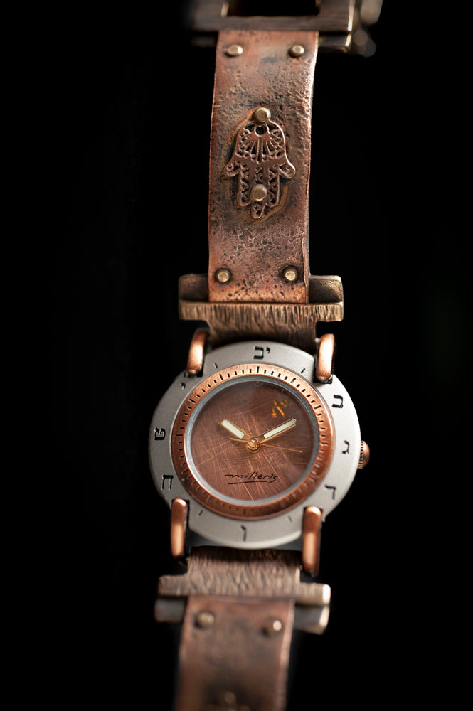 Close-up of brushed copper dial with Hebrew numerals on handcrafted copper watch – ALEPH Hamsa