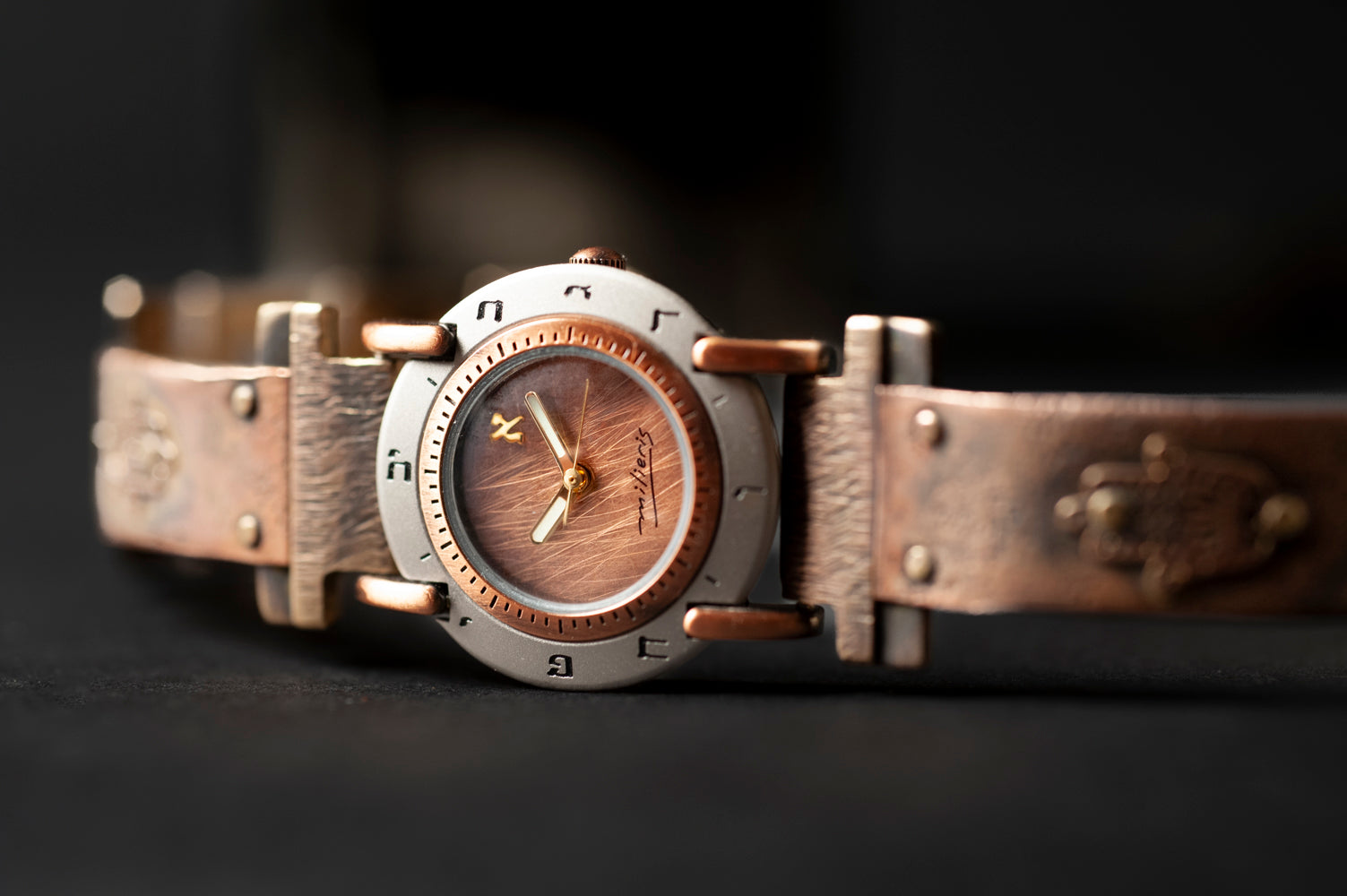 Close-up of brushed copper dial with Hebrew numerals on handcrafted copper watch – ALEPH Hamsa