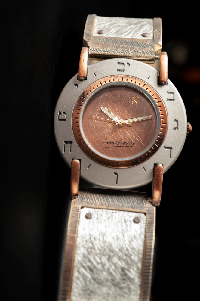 Close-up of the brushed copper dial with Hebrew numerals on a large sterling silver watch, black background - ALEPH Luna