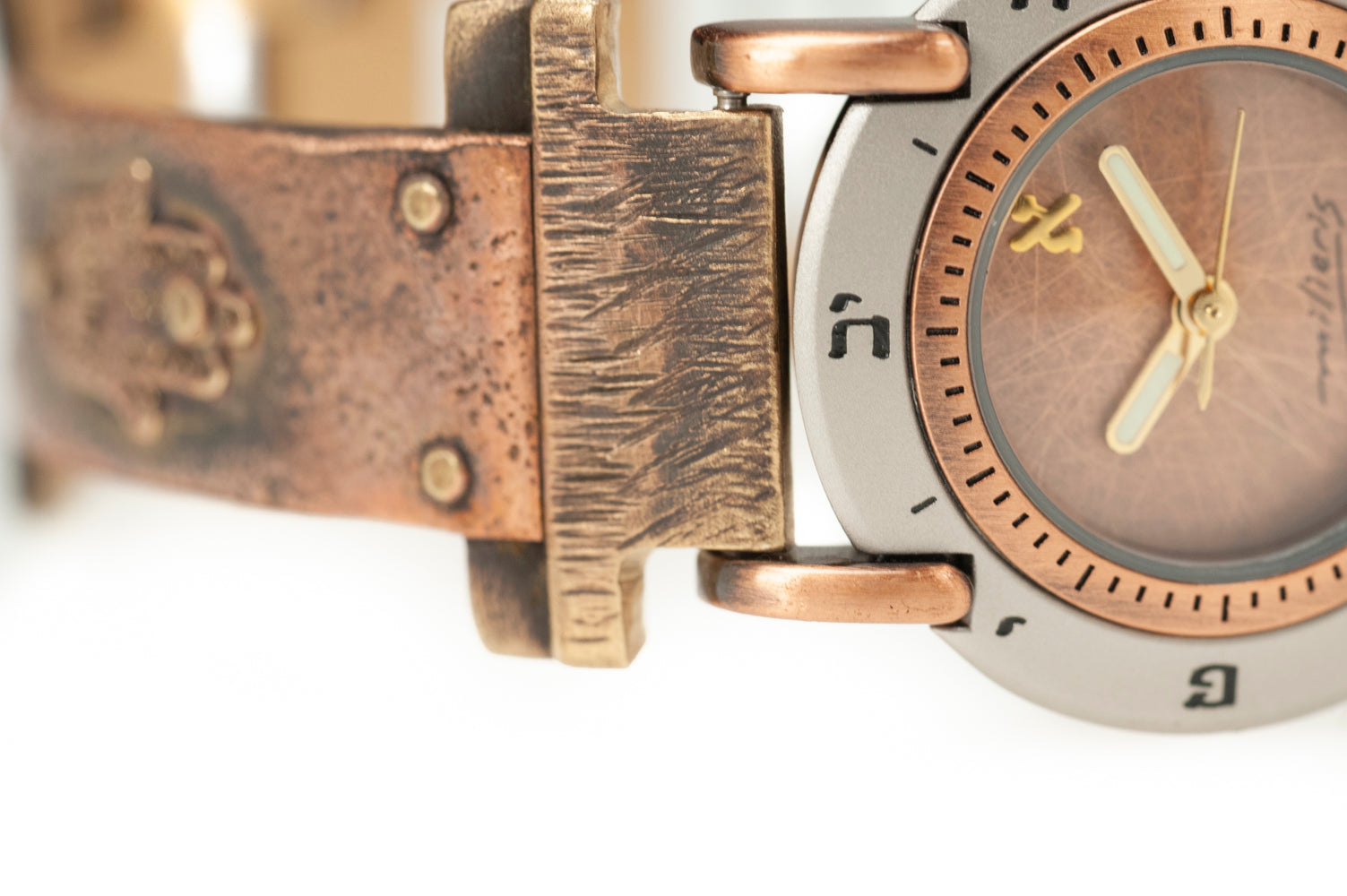 Close-up of brushed copper dial with Hebrew numerals on handcrafted copper watch – ALEPH Hamsa