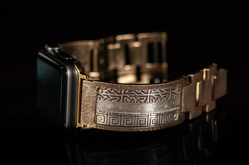 Close-up of the details on the sterling silver Bard. iWatch facing left on a black background.