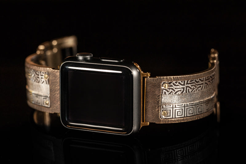 Bard sterling silver iWatch facing to the left on a black background.