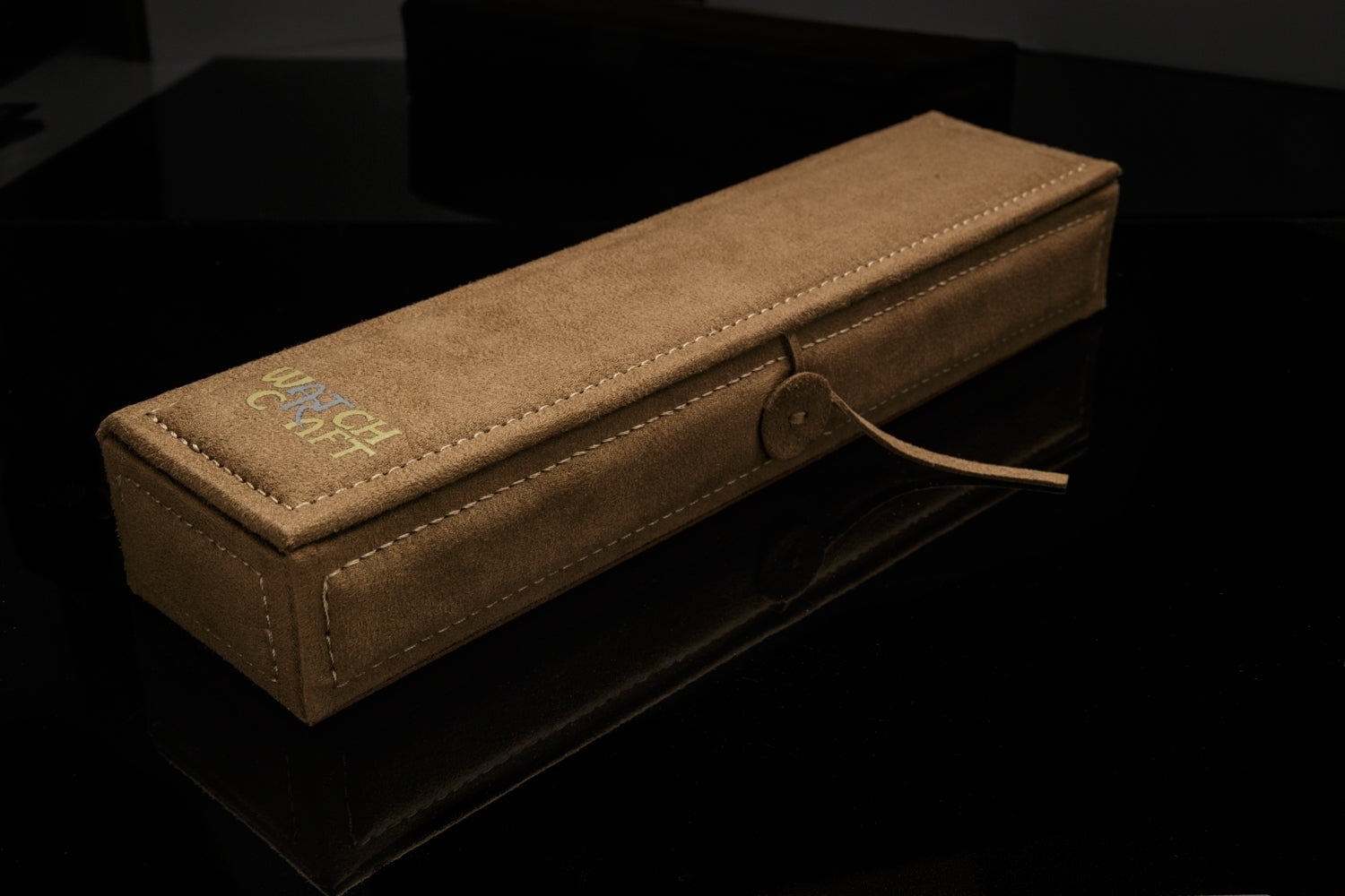 Your timepiece is packaged in a rich brown, suede box stamped with the WATCHCRAFT logo. Pictured closed.